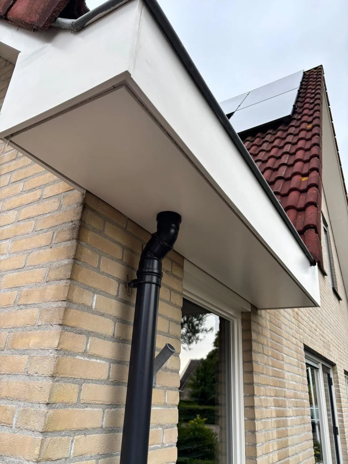 Witte overstek en boeideel boven een voordeur